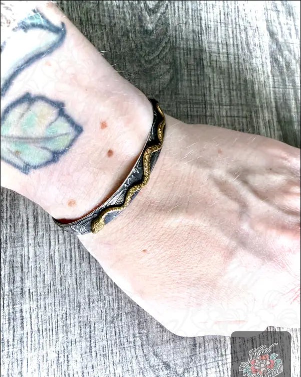 Did you know that wearing a piece of jewelry can symbolize transformation? 🌿

Our Floral Sterling Silver and Brass Snake Cuff Bracelet elegantly captures this concept. 

With a mystical snake winding through enchanting dogwood flowers, it's a delightful blend of nature and magic. 

Adjustable and perfect for everyday wear, this bracelet effortlessly complements any style.

Transform your look today—now at $105.00! 

Shop here: 

#NatureInspired #JewelryWithMeaning #MadMeadowDesigns #SnakeBracelet #FloralDesign
