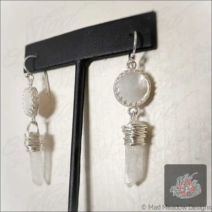 ✨ Embrace your inner goddess! ✨ These stunning White Goddess Mother of Pearl and Quartz Point Dangle Earrings are your new must-have accessory for spiritual growth and elegance. 

🌟 Features: 
💎 12mm round white mother of pearl 
🔮 Wrapped with healing quartz points 
💫 Promotes love, intuition & emotional healing 
🌊 Connected to water for fluidity & abundance 

Don’t miss out—grab yours for just $155.00 before the campaign ends! Shop now: https://ssdlr.shop/l/e680269d 

#MadMeadowDesigns #DangleEarrings #GemstoneJewelry #SpiritualFashion #ShopNow