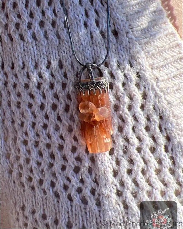 Could this pendant be your new spiritual companion? 

Meet the Orange Crystal Pendant Necklace, crafted with a raw Aragonite crystal and oxidized sterling silver. 

This piece isn’t just jewelry; it’s a stylish talisman that connects you to the Earth’s energy—perfect for those who crave a deeper bond with the universe. 

Imagine wearing a beautiful reminder to stay grounded and reverent towards nature. 

Now at $115.00, it’s time to wear your intentions! 

#NatureJewelry #BohoStyle #SpiritualJewelry #MadMeadowDesigns #RawCrystal