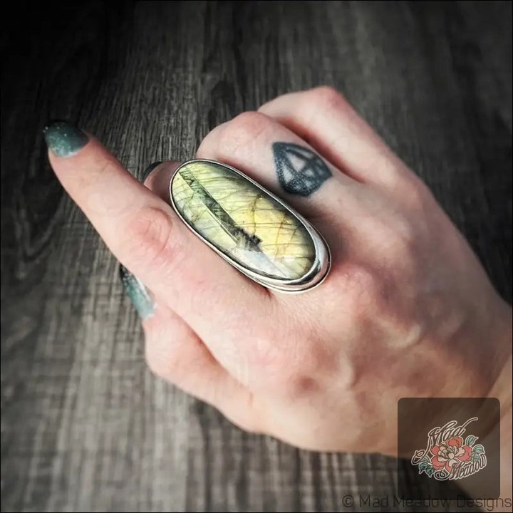 Can a ring truly transform your vibe? 

This Oversized Flashy Labradorite Ring does just that! 🌟 
Crafted with a mesmerizing 20x50mm cabochon, it’s not just stunning, it’s all about comfort and self-discovery. 

Feel the energy of this enchanting gemstone as it guides you through the mysteries of the universe. 

Perfectly adjustable for sizes 7 to 9 (and beyond if you ask!). 

Step into your power for only $220.00 and connect with the magic within! 

Shop now: 

#GemstoneJewelry #Labradorite #WitchyVibes #BohoStyle #MadMeadowDesigns