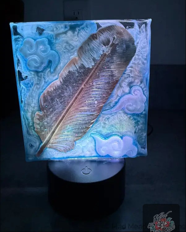 What if your nightlight could paint your dreams in pastel hues? ✨ 

Meet the whimsical golden feather resin lamp, your new bedside buddy! 

This charming piece doesn’t just illuminate; it creates a dreamy sanctuary. 🌙 With a rainbow of color options, you can easily set the mood - whether it’s a soft glow for relaxation or vibrant hues for inspiration. 

Powered by USB or batteries, it’s as versatile as it is enchanting. Plus, a handy remote puts you in control! 

Transform your space for only $55.00. 

👉 

#DreamySanctuary #WhimsicalLighting #HomeDecor #BohoStyle #MadMeadowDesigns