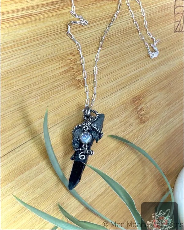 Ever felt the need to reclaim your inner power? 

Our Black Raw Aegirine Crystal and Rainbow Moonstone Pendant Necklace does just that! 

Handcrafted with sterling silver, it combines the grounding energy of Aegirine with the ethereal charm of Rainbow Moonstone. This mystical piece not only elevates your style but also enhances courage, protects your spirit, and helps you navigate transformations effortlessly. 

Own your authenticity—now at $110.00! 

👉 

#MadMeadowDesigns #BohoJewelry #CrystalHealing #Handcrafted #MysticalJewelry