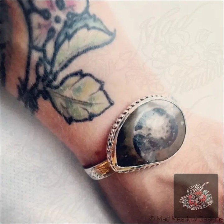 Did you know that wearing ancient relics can connect you to the past? ✨ 

Our Alaskan Ammonite Sterling Silver Cuff Bracelet is not just jewelry; it's a piece of history. Handcrafted from a unique sterling silver napkin ring, it carries the wisdom of 66 million years. 

Embrace change, enhance your dreams, and let go of negativity as you adorn your wrist with this striking piece. 

Now at $195.00, it’s the perfect blend of style and soulful connection. 

Discover your new favorite accessory here: 

#Ammonite #HandcraftedJewelry #BohoStyle #MadMeadowDesigns #NatureInspired
