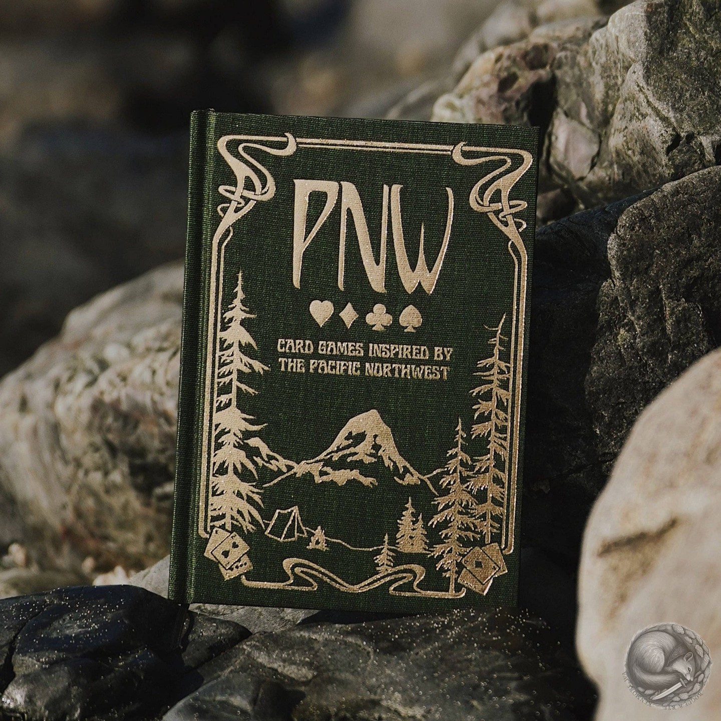 Today’s Featured Game: PNW: Card Games Inspired by the Pacific Northwest. With its beautiful illustrations and foiled cover, this little book is a treasure! A charming table-piece, ready for a quick round (or three) of play. 🦅

https://roguerye.com