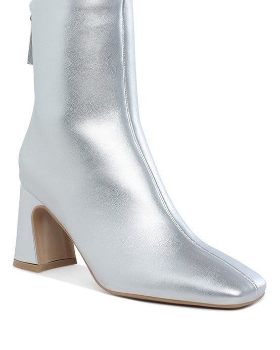 Simba Square Toe Metallic Ankle Boots
 68.72 USD

 Inspired by the groovy curves and statement heels of the '70s, our ankle boots are here to get 'em talking. Stacked up on a flared block heel and imagined in metallic faux leather, this above-the-ankle pair with back zipper closure easily hot-foots its way with bold mini dresses and classic denim.Type: BootsUpper Material: Metallic Faux LeatherOuter Sole: TPRClosed Square ToeFlared Block HeelBack Zipper ClosureHeel Height: 2.5 inchesSH5174
 
Style: Casual
Closure: Zipper 
Heel Height: 2.5 inches
 Made In: China
 Material Composition: Metallic Faux Leather

 https://fashionsenvy.com/products/simba-square-toe-metallic-ankle-boots