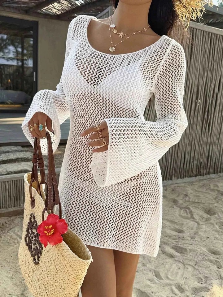 Picture this: a breezy evening by the seaside, the sun setting in hues of orange and pink. You're wrapped in our Long Sleeve Knit Cover Up Dress, its openwork details catching the gentle breeze, the slit adding a touch of effortless elegance. Made from soft, slightly stretchy polyester, it's the perfect companion for those moments when you want to feel cozy yet chic. Whether you're strolling along the shore or enjoying a quiet coffee, this dress is your go-to for relaxed, stylish vibes. #FashionStory #LongSleeveDress #KnitCoverUp #OpenworkFashion #BeachStyle #CasualChic